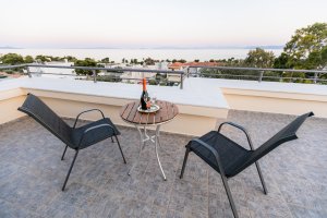 Βεράντα της Villa Memories με καθιστικό και θέα τη θάλασσα στο ηλιοβασίλεμα